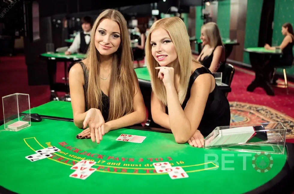 Ruang permainan meja live dengan dealer dan layar taruhan